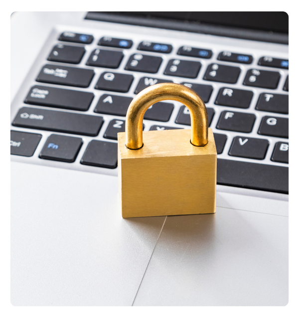 A gold padlock on a laptop keyboard